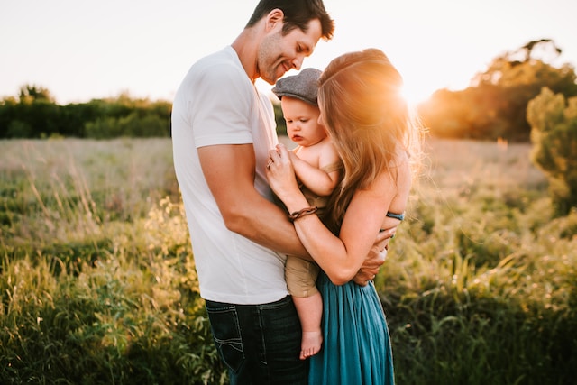 Young family holding baby considering health insurance in Oklahoma